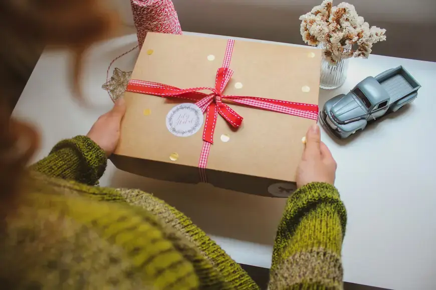 Happy person excitedly receiving and opening a thoughtful gift package, capturing the joy of international gift delivery